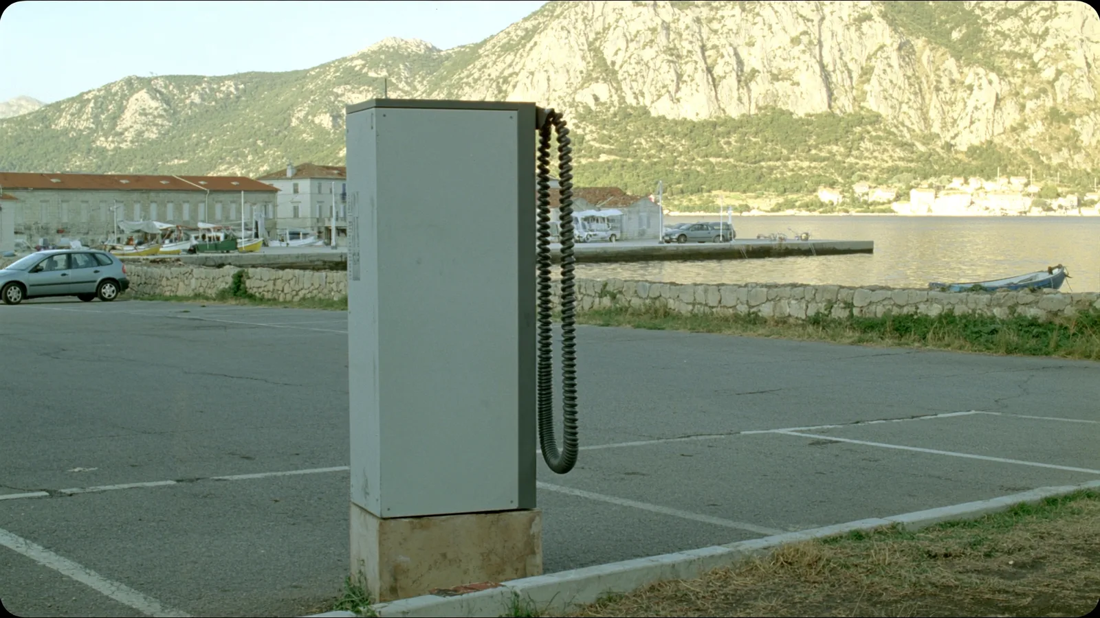 A public electric vehicle charging point on the seafront in a small Montenegrin coastal town