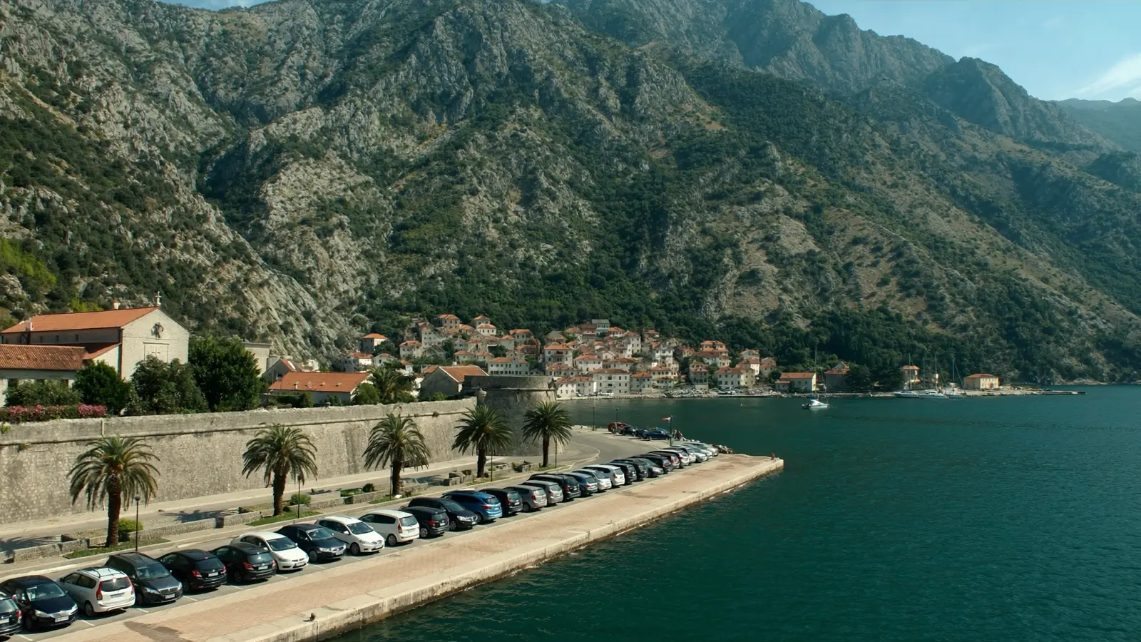 The waterfront car park at Kotor, with the old town wall on one side and the bay on the other