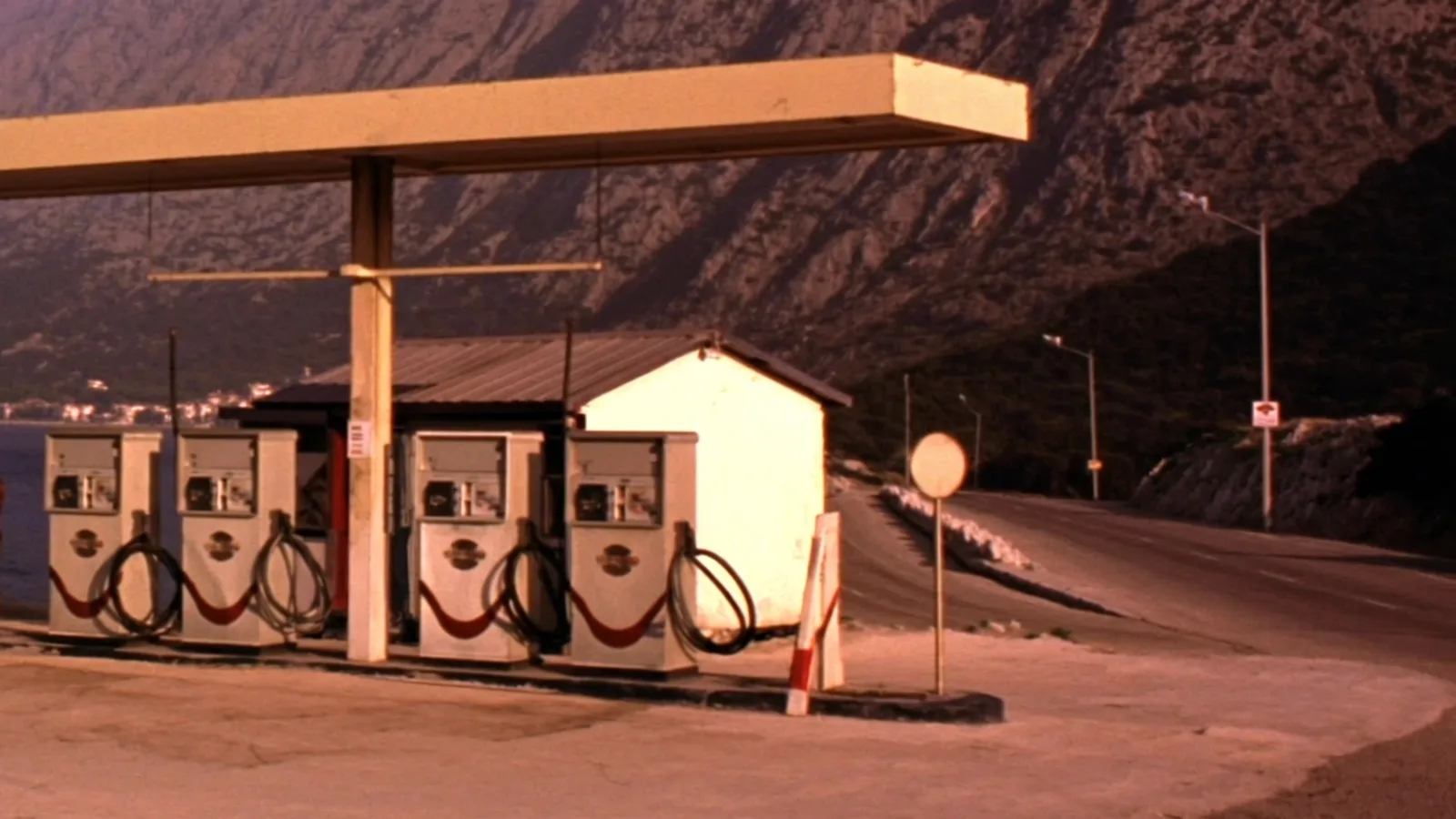 Fuel pumps at a small coastal petrol station in Montenegro in late afternoon light